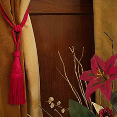 Vibrant red tassel gracefully adorns a curtain