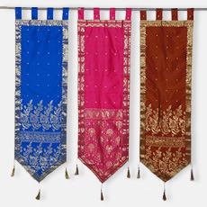 Three vibrant banners with tassels hanging in the air